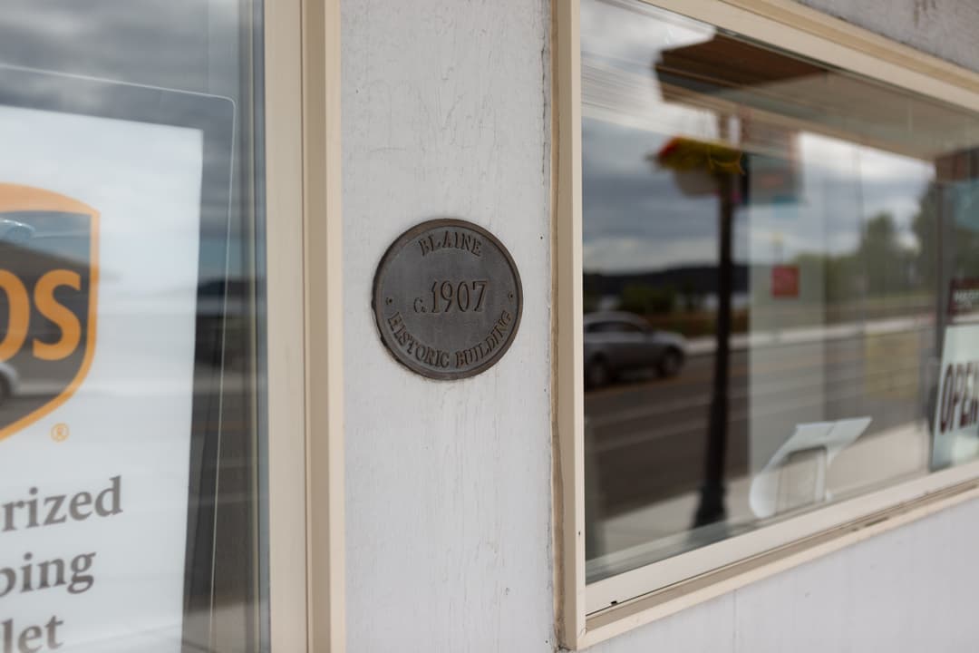 A blaine historic building plaque on the side of a building