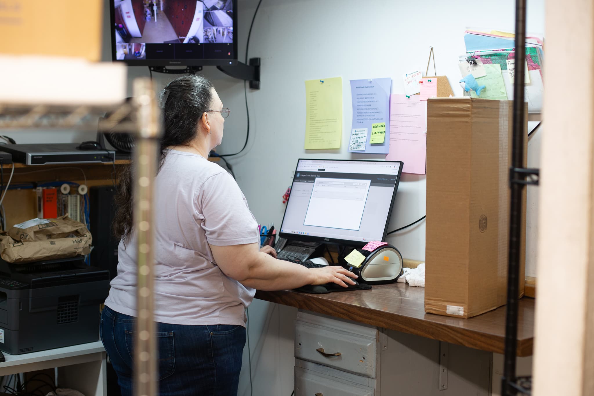 a hagens employee entering package information at a computer