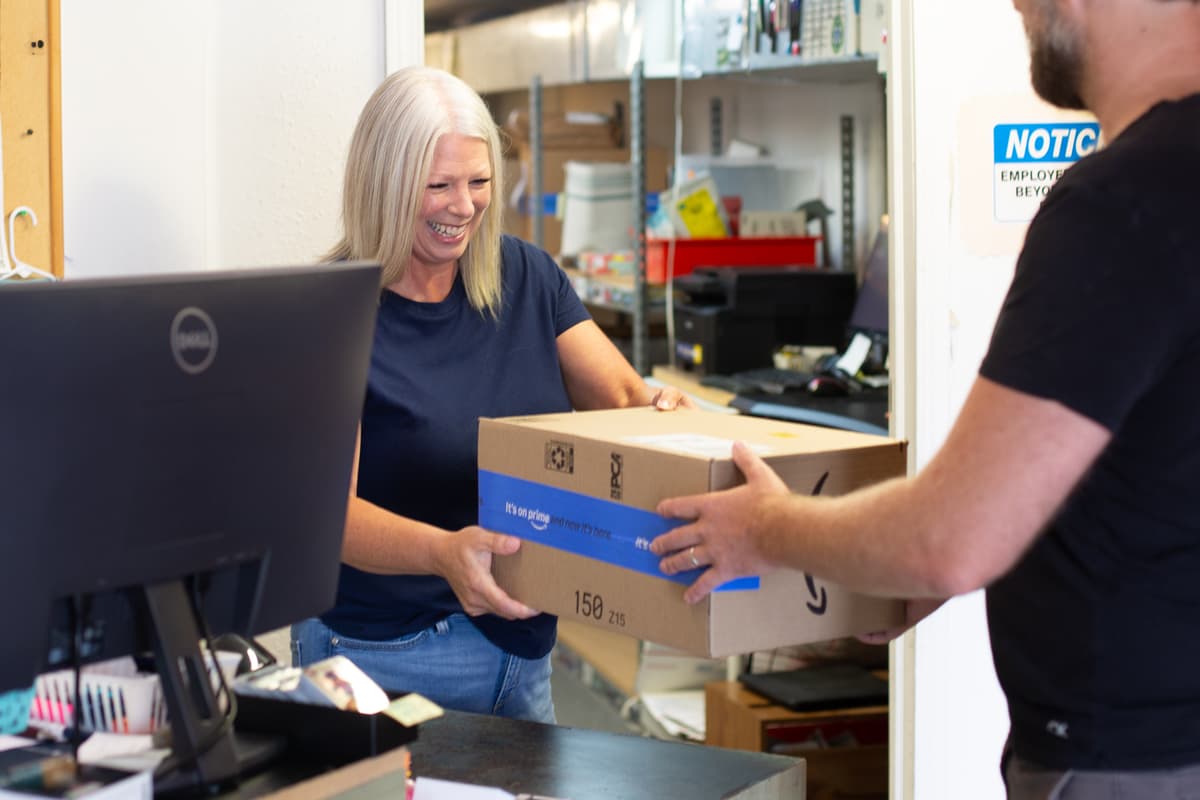 Kelli Hagen giving a package to a customer